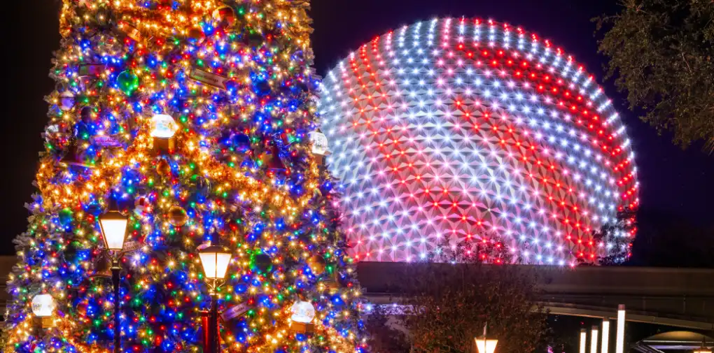 A brightly lit Christmas tree with colorful lights next to a glowing geodesic sphere illuminated with red, white, and blue lights