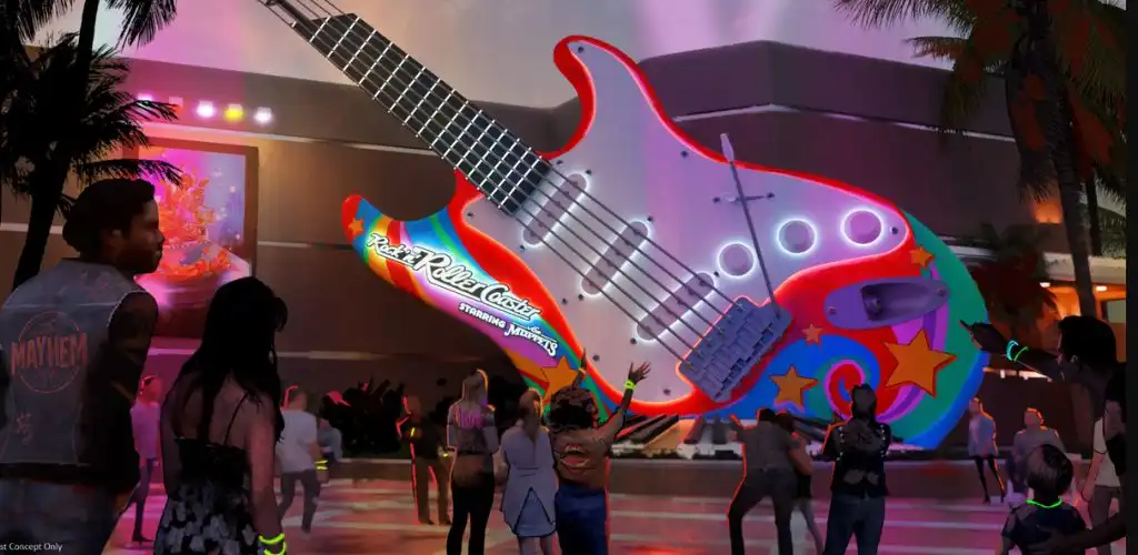 Giant neon Rock ’n’ Roller Coaster guitar sculpture lit up at night as guests walk past