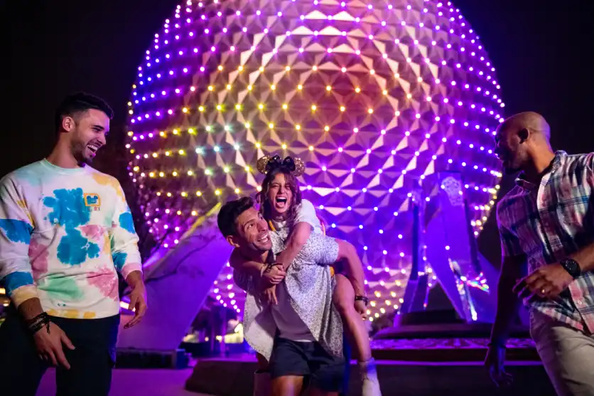 Epcot park image featuring vibrant attractions and colorful lights at night, showcasing the festive atmosphere.