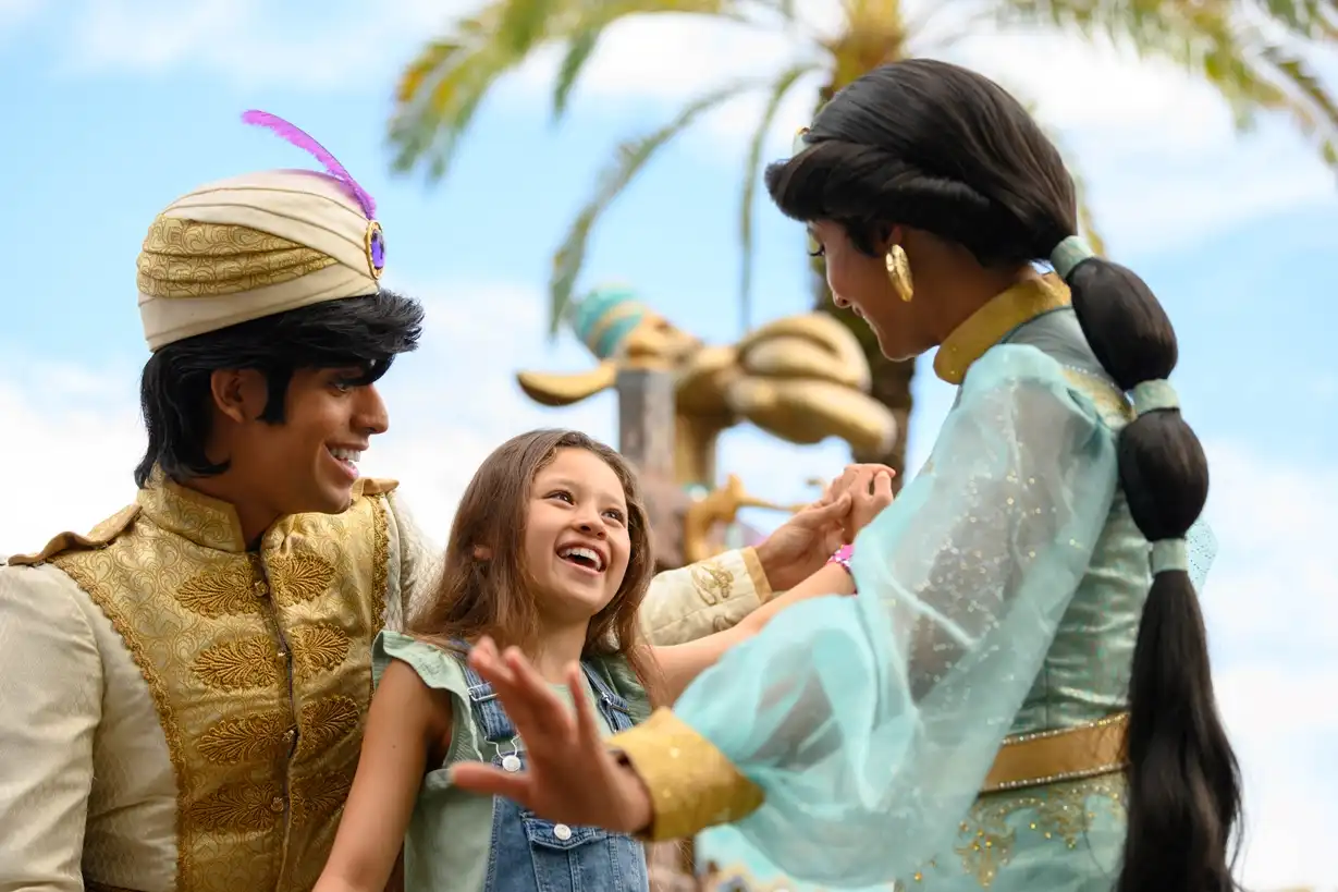 Excited young girl meeting Aladdin and Princess Jasmine at Walt Disney World, sharing a magical moment with the beloved Disney characters