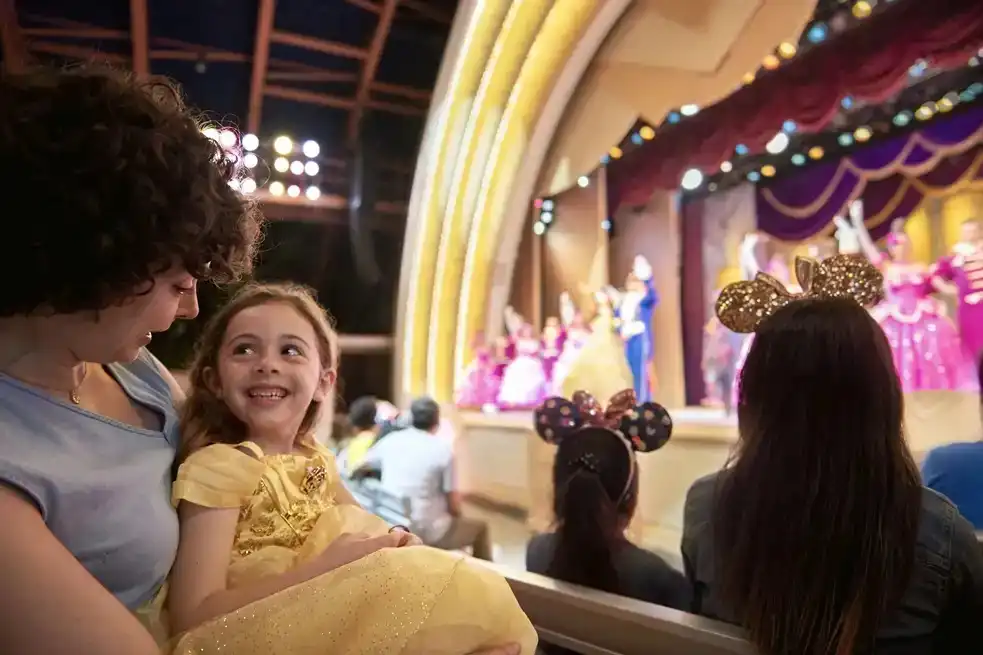 Mother and daughter enjoying Beauty and the Beast Live on Stage at Disney’s Hollywood Studios, as beloved characters perform on stage