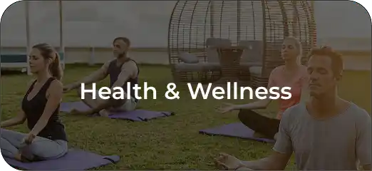 Group of people practicing outdoor yoga on mats by the water promoting health and wellness.