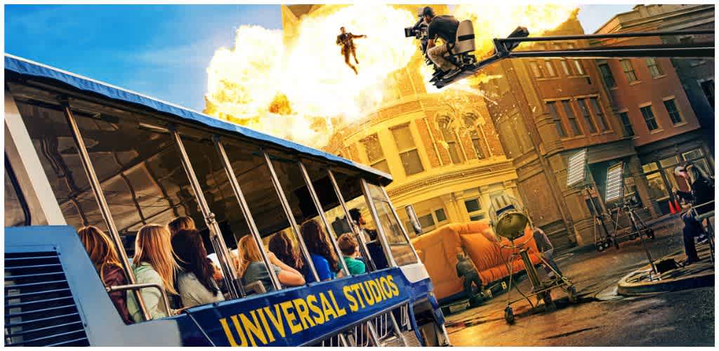 Supposed explosion scene with cast and crew filming an action sequence on a city street during daylight