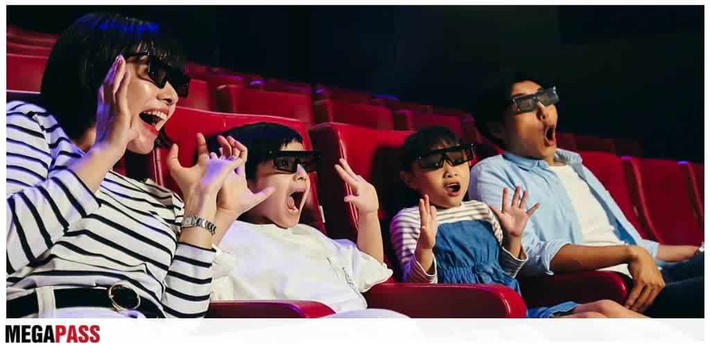 Group of children and an adult watching 3D movie with excitement at a theater