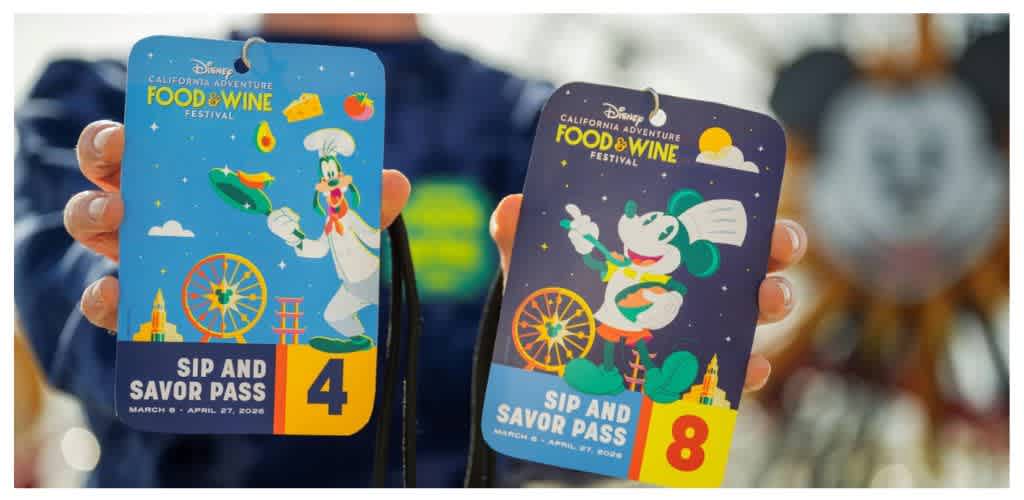 Two colorful Disneyland Food and Wine Festival sip and savor passes, one blue with Donald Duck and one purple with Minnie Mouse, held by a person with a blurred background.
