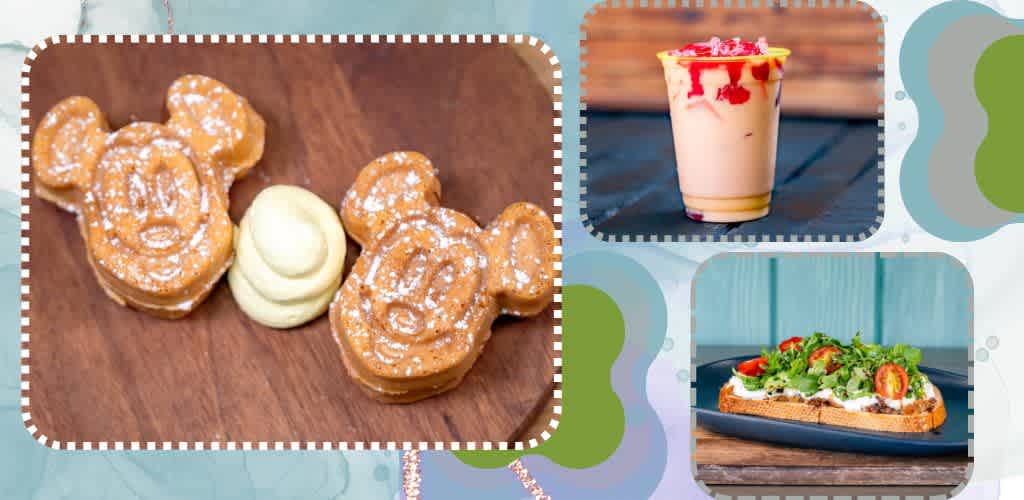 Three Mickey Mouse shaped waffles with powdered sugar and a dollop of butter, a strawberry frosting milkshake, and a veggie topped sandwich on a wooden surface