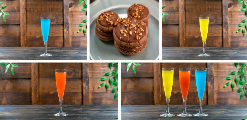 Colorful layered drinks and a plate of chocolate cookies with nuts on a wooden table with green foliage in the background