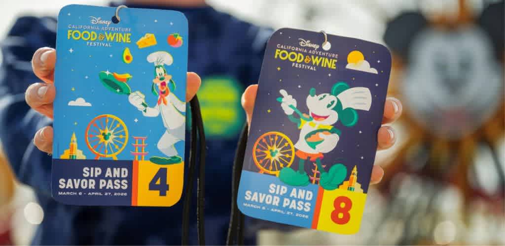 Two colorful Disney California Adventure Food and Wine Festival sip and savor passes, one with the number four and the other with the number eight, held by a person's hand.