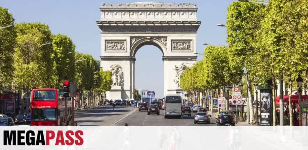A view of the Arc de Triomphe in Paris with cars and buses on a busy street lined with green trees.
