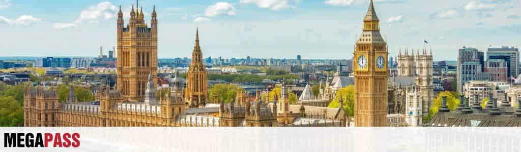 A cityscape featuring historic and modern buildings with clock towers, green trees, and a partly cloudy sky above London England.