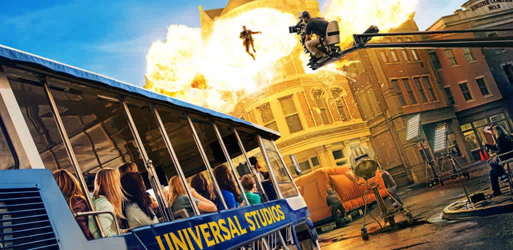 A movie scene showing a bus with passengers, a person with a camera crane, and a helicopter firing flames above a city street.
