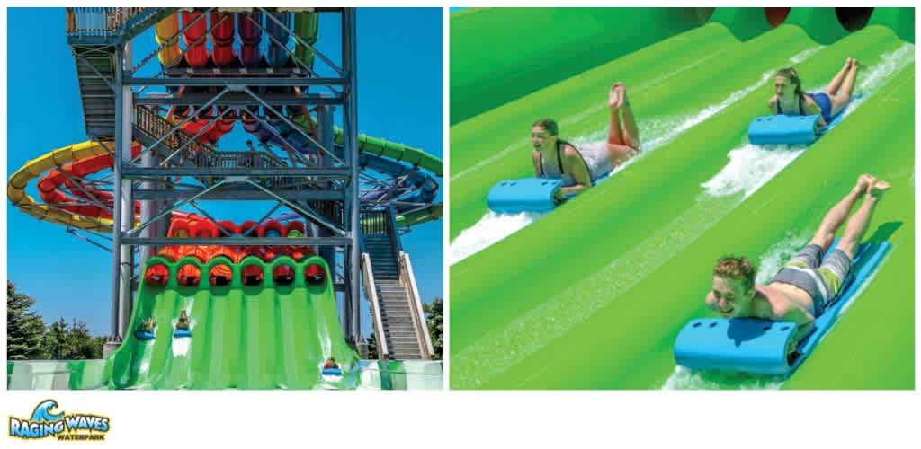 Three children ride down green water slides at a waterpark with a large multi-slide tower in the background.