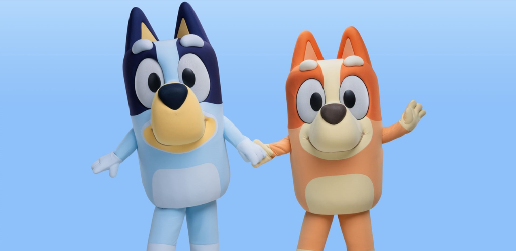 Two cartoon dog characters holding hands, one in blue and the other in orange, smiling against a light blue background.