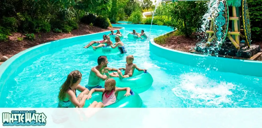 Families enjoying a relaxing time on a lazy river ride at White Water theme park surrounded by lush greenery