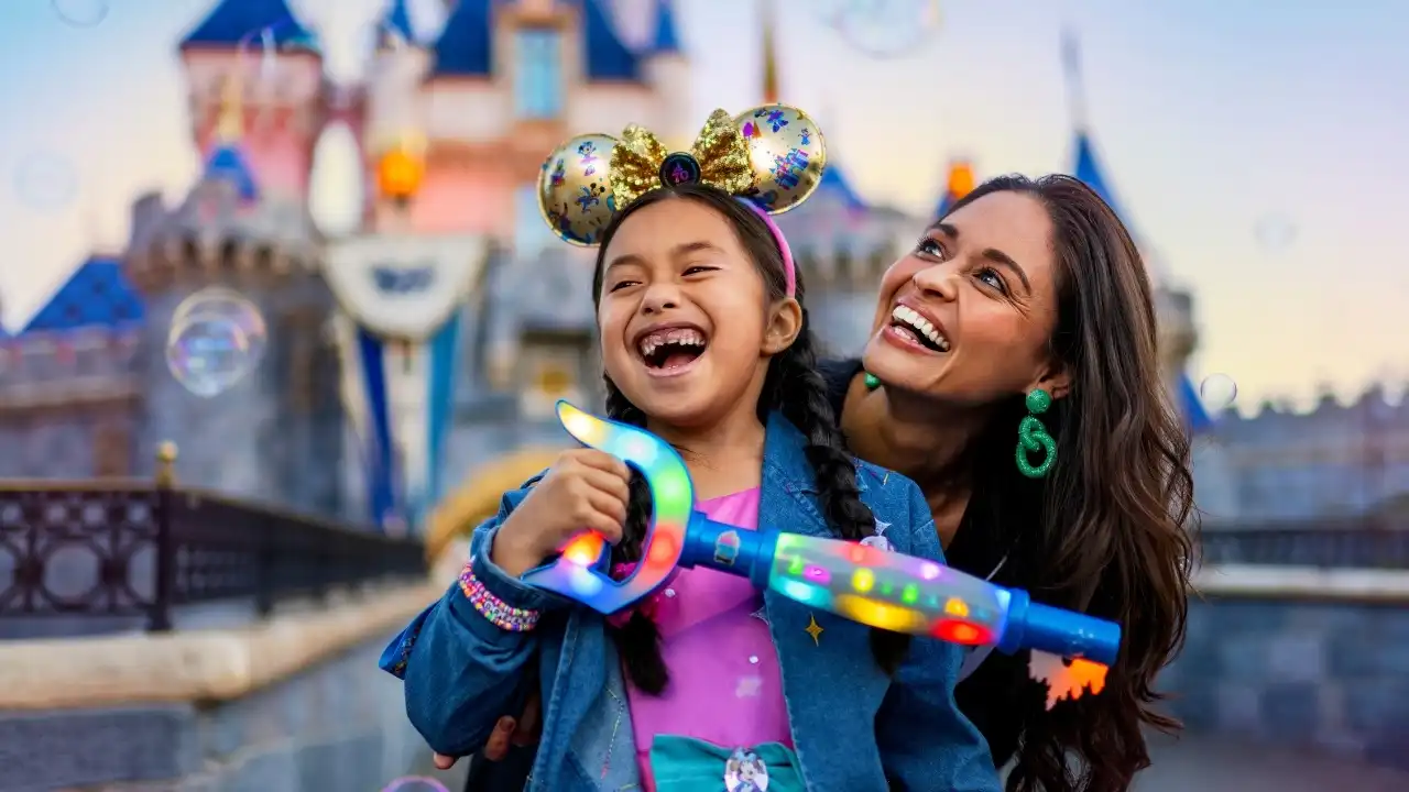 Mother and daughter laughing together with Mickey ears at Disneyland castle