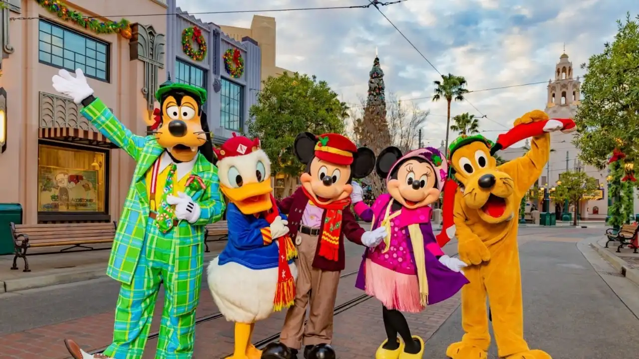 Mickey, Minnie, Donald, Goofy, and Pluto in holiday outfits at Disneyland Resort