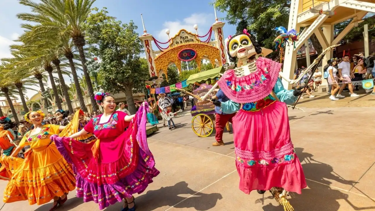 Miguel from Coco with performers at Plaza de la Familia at Disney California Adventure