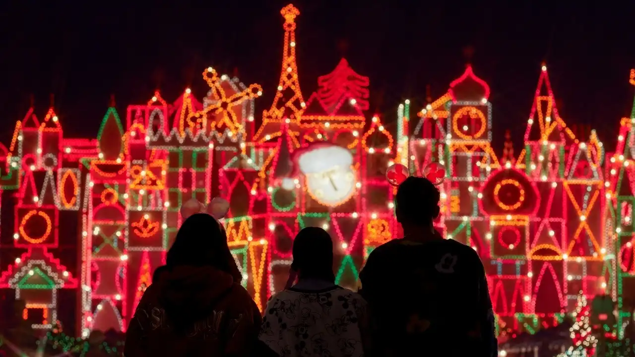 Sleeping Beauty Castle lit up with holiday lights at night at Disneyland Resort