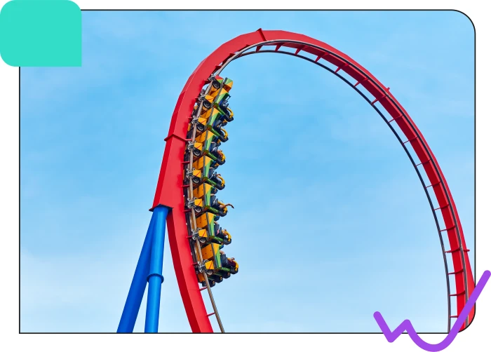 A group of riders on a roller coaster with a red track and yellow cars ascending a steep hill against a blue sky
